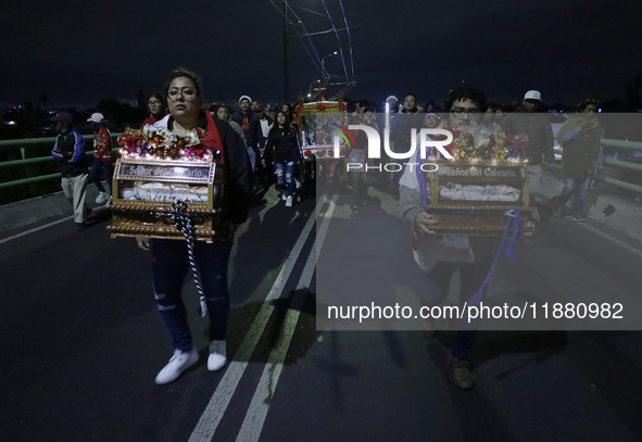 Residents of the town of Culhuacan in Mexico City, on December 18, 2024,  walk on a vehicular bridge while participating in a posada on Chri...