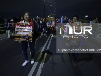 Residents of the town of Culhuacan in Mexico City, on December 18, 2024,  walk on a vehicular bridge while participating in a posada on Chri...