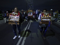 Residents of the town of Culhuacan in Mexico City, on December 18, 2024,  walk on a vehicular bridge while participating in a posada on Chri...