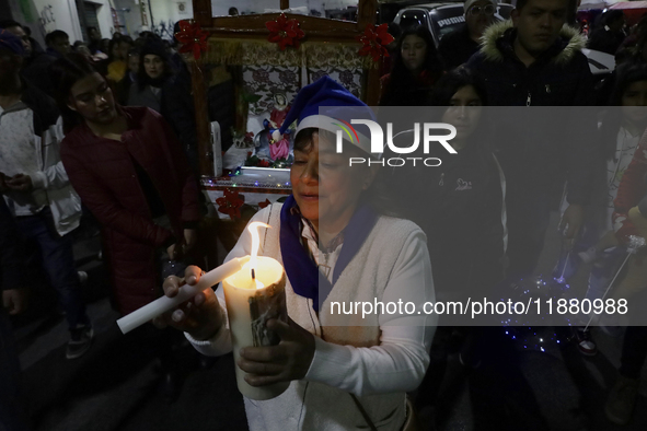 Residents of the town of Culhuacan in Mexico City, on December 18, 2024,  walk on a vehicular bridge while participating in a posada on Chri...