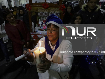 Residents of the town of Culhuacan in Mexico City, on December 18, 2024,  walk on a vehicular bridge while participating in a posada on Chri...