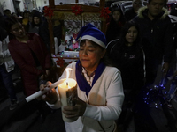 Residents of the town of Culhuacan in Mexico City, on December 18, 2024,  walk on a vehicular bridge while participating in a posada on Chri...