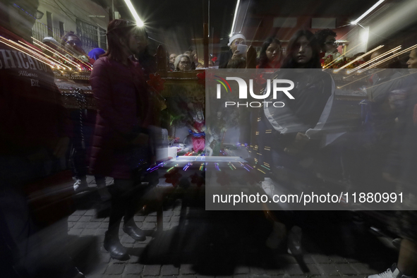 Residents of the town of Culhuacan in Mexico City, on December 18, 2024,  walk on a vehicular bridge while participating in a posada on Chri...