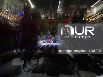 Residents of the town of Culhuacan in Mexico City, on December 18, 2024,  walk on a vehicular bridge while participating in a posada on Chri...