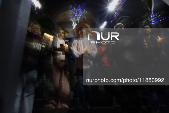 Residents of the town of Culhuacan in Mexico City, on December 18, 2024,  walk on a vehicular bridge while participating in a posada on Chri...