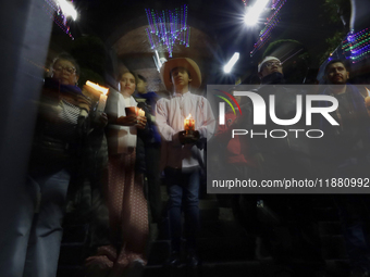 Residents of the town of Culhuacan in Mexico City, on December 18, 2024,  walk on a vehicular bridge while participating in a posada on Chri...