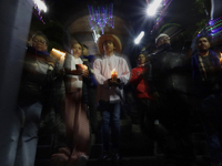 Residents of the town of Culhuacan in Mexico City, on December 18, 2024,  walk on a vehicular bridge while participating in a posada on Chri...