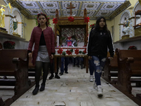 Residents of the town of Culhuacan in Mexico City, on December 18, 2024,  walk on a vehicular bridge while participating in a posada on Chri...