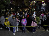 Residents of the town of Culhuacan in Mexico City, on December 18, 2024,  walk on a vehicular bridge while participating in a posada on Chri...