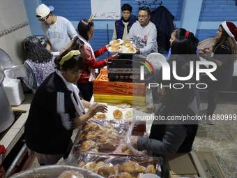 Residents of the town of Culhuacan in Mexico City, on December 18, 2024,  walk on a vehicular bridge while participating in a posada on Chri...