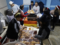 Residents of the town of Culhuacan in Mexico City, on December 18, 2024,  walk on a vehicular bridge while participating in a posada on Chri...