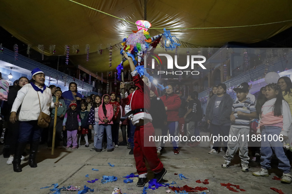 Residents of the town of Culhuacan in Mexico City, on December 18, 2024,  walk on a vehicular bridge while participating in a posada on Chri...