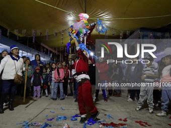 Residents of the town of Culhuacan in Mexico City, on December 18, 2024,  walk on a vehicular bridge while participating in a posada on Chri...