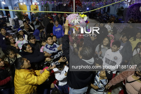 Residents of the town of Culhuacan in Mexico City, on December 18, 2024,  walk on a vehicular bridge while participating in a posada on Chri...