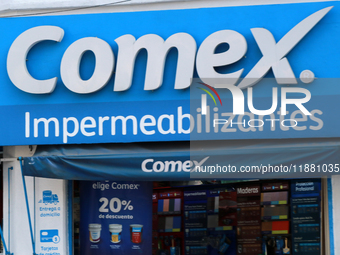 The logo of the Mexican architectural, industrial, and specialized paints and coatings company Comex is seen on a facade of the same company...