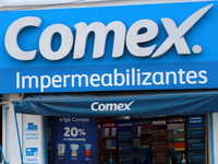 The logo of the Mexican architectural, industrial, and specialized paints and coatings company Comex is seen on a facade of the same company...