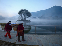 A Nepali woman walks along the edge of the Taudaha wetland on the outskirts of Kathmandu, Nepal, on December 19, 2024. (