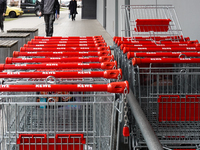 Rows of REWE shopping carts line up outside a supermarket in Munich, Bavaria, Germany, on December 18, 2024 (