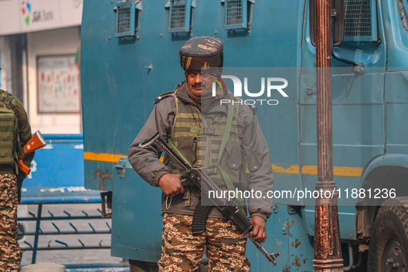 An Indian security personnel stands guard along a road in Srinagar, Jammu and Kashmir, on December 19, 2024. Indian security forces kill fiv...