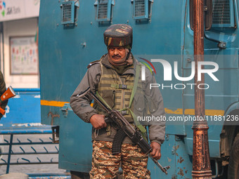 An Indian security personnel stands guard along a road in Srinagar, Jammu and Kashmir, on December 19, 2024. Indian security forces kill fiv...