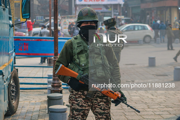 An Indian security personnel stands guard along a road in Srinagar, Jammu and Kashmir, on December 19, 2024. Indian security forces kill fiv...