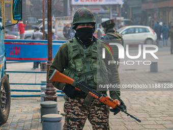 An Indian security personnel stands guard along a road in Srinagar, Jammu and Kashmir, on December 19, 2024. Indian security forces kill fiv...