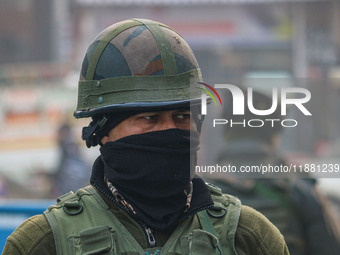 An Indian security personnel stands guard along a road in Srinagar, Jammu and Kashmir, on December 19, 2024. Indian security forces kill fiv...