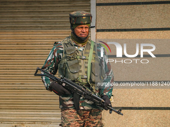 An Indian security personnel stands guard along a road in Srinagar, Jammu and Kashmir, on December 19, 2024. Indian security forces kill fiv...