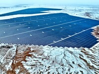 An aerial view shows a solar array and wind turbine cluster at Beitan New Energy Industrial Park deep in the desert in Zhangye, China, on De...