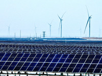 An aerial view shows a solar array and wind turbine cluster at Beitan New Energy Industrial Park deep in the desert in Zhangye, China, on De...