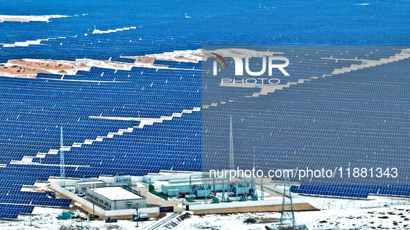 An aerial view shows a solar array and wind turbine cluster at Beitan New Energy Industrial Park deep in the desert in Zhangye, China, on De...