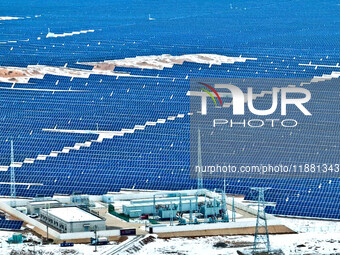 An aerial view shows a solar array and wind turbine cluster at Beitan New Energy Industrial Park deep in the desert in Zhangye, China, on De...