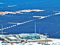 An aerial view shows a solar array and wind turbine cluster at Beitan New Energy Industrial Park deep in the desert in Zhangye, China, on De...