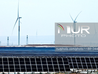 An aerial view shows a solar array and wind turbine cluster at Beitan New Energy Industrial Park deep in the desert in Zhangye, China, on De...