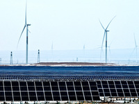 An aerial view shows a solar array and wind turbine cluster at Beitan New Energy Industrial Park deep in the desert in Zhangye, China, on De...