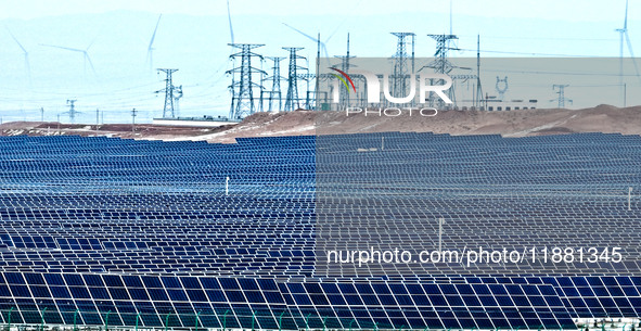 An aerial view shows a solar array and wind turbine cluster at Beitan New Energy Industrial Park deep in the desert in Zhangye, China, on De...