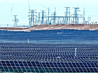 An aerial view shows a solar array and wind turbine cluster at Beitan New Energy Industrial Park deep in the desert in Zhangye, China, on De...