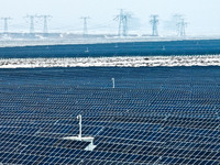 An aerial view shows a solar array and wind turbine cluster at Beitan New Energy Industrial Park deep in the desert in Zhangye, China, on De...