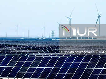 An aerial view shows a solar array and wind turbine cluster at Beitan New Energy Industrial Park deep in the desert in Zhangye, China, on De...