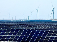 An aerial view shows a solar array and wind turbine cluster at Beitan New Energy Industrial Park deep in the desert in Zhangye, China, on De...