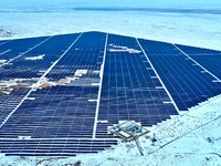 An aerial view shows a solar array and wind turbine cluster at Beitan New Energy Industrial Park deep in the desert in Zhangye, China, on De...