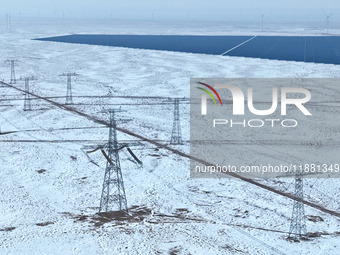 An aerial view shows a solar array and wind turbine cluster at Beitan New Energy Industrial Park deep in the desert in Zhangye, China, on De...