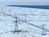 An aerial view shows a solar array and wind turbine cluster at Beitan New Energy Industrial Park deep in the desert in Zhangye, China, on De...