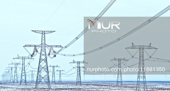 An aerial view shows a solar array and wind turbine cluster at Beitan New Energy Industrial Park deep in the desert in Zhangye, China, on De...