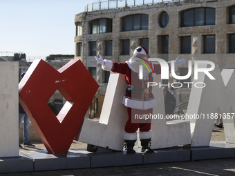 In Jerusalem, Israel, on December 19, 2024, Christian Palestinian Issa Kassissieh, dressed as Santa Claus, greets the public from the old ci...