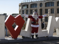 In Jerusalem, Israel, on December 19, 2024, Christian Palestinian Issa Kassissieh, dressed as Santa Claus, greets the public from the old ci...