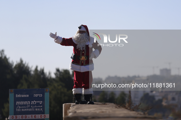 In Jerusalem, Israel, on December 19, 2024, Christian Palestinian Issa Kassissieh, dressed as Santa Claus, greets the public from the old ci...