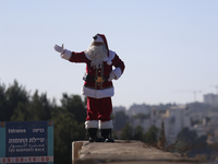 In Jerusalem, Israel, on December 19, 2024, Christian Palestinian Issa Kassissieh, dressed as Santa Claus, greets the public from the old ci...