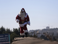 In Jerusalem, Israel, on December 19, 2024, Christian Palestinian Issa Kassissieh, dressed as Santa Claus, greets the public from the old ci...