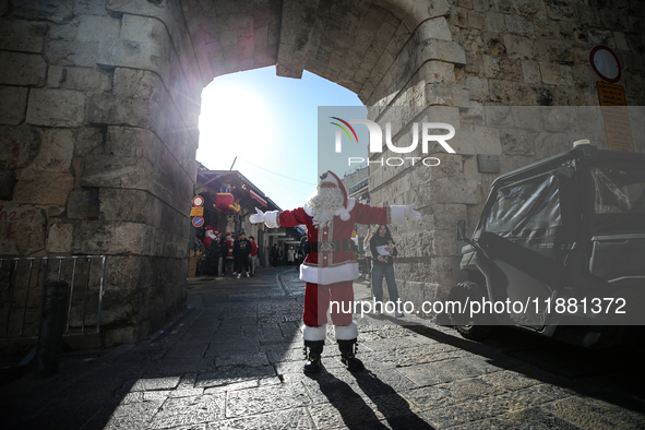 In Jerusalem, Israel, on December 19, 2024, Christian Palestinian Issa Kassissieh, dressed as Santa Claus, greets the public from the old ci...